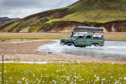 4WD car wades river, Iceland