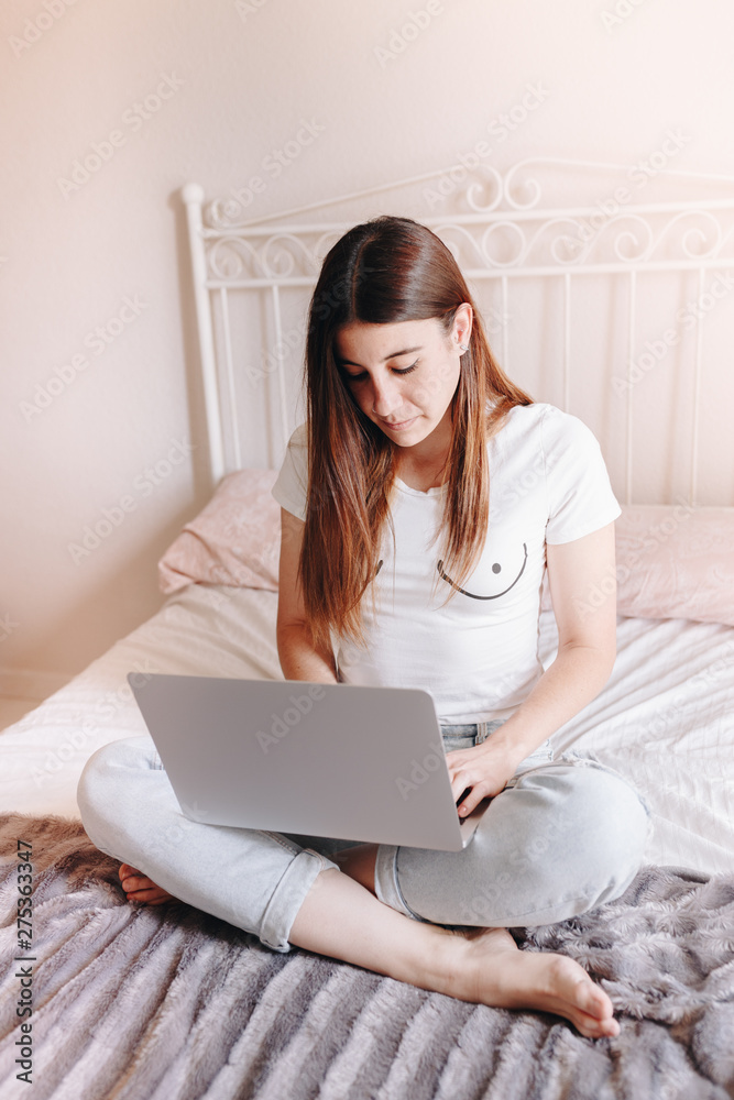 beautiful young woman writing and searching on laptop beautiful young woman writing and searching on laptop