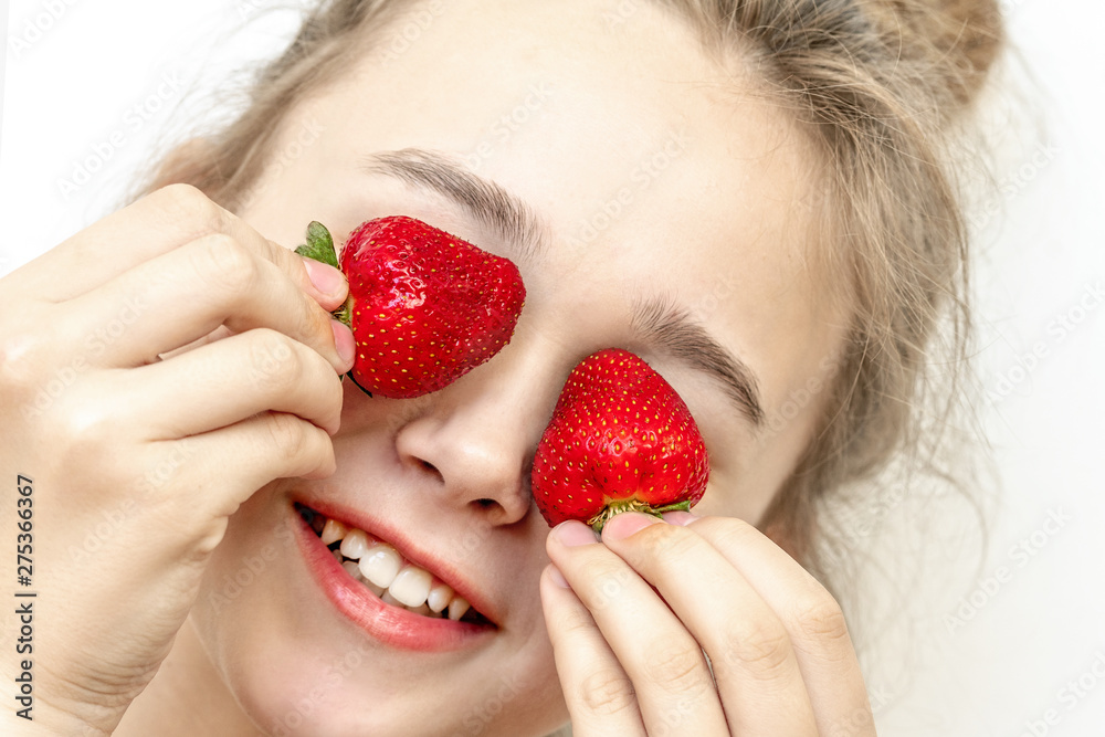 Strawberry Eyes . Beautiful young woman holding strawberries in eyes like binoculars. Healthy, lifestyle concept. Strawberry Eyes . Beautiful young woman holding strawberries in eyes like binoculars. Healthy, lifestyle concept.