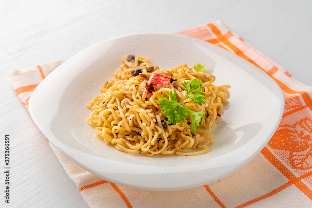 cooked hot meal or dish with spaghetii crab meat mushrooms and spice
