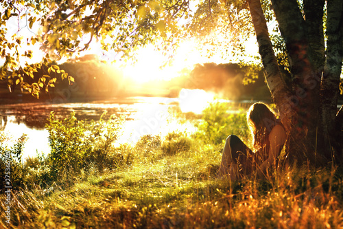 woman in sunset by lake