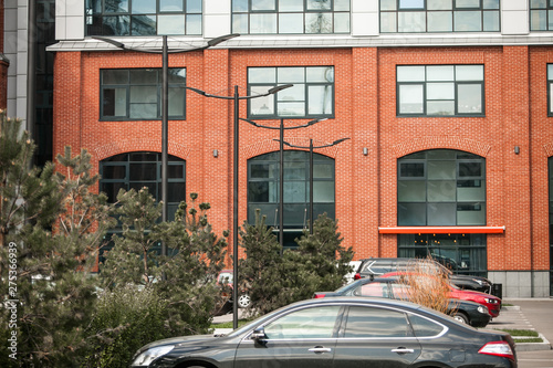 Decorative lighting pole in cityscape. Modern loft building from red brick in downtown area. Manufacture Arma in Moscow. Industrial design in city architecture. Business concept. photo