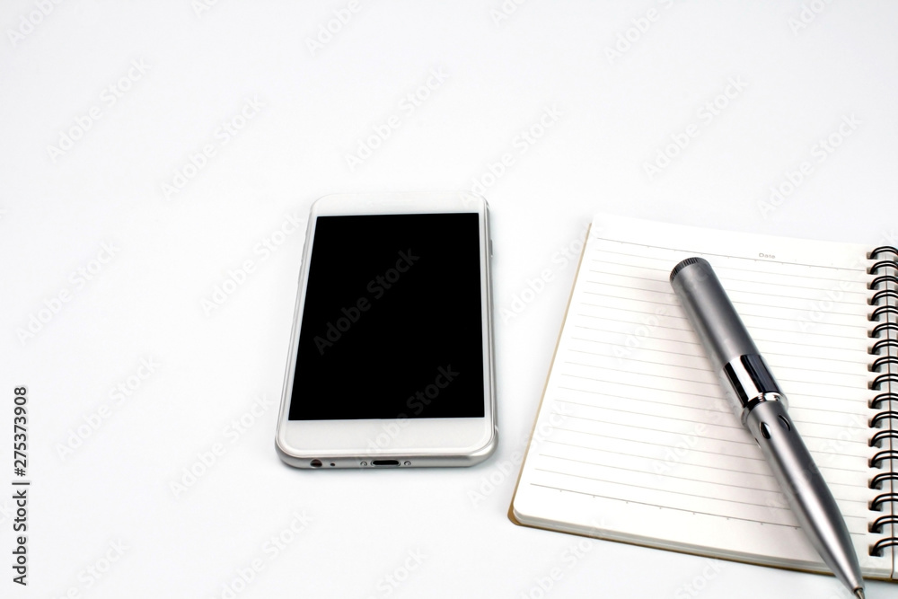 smartphone,memo pad and pencil on white desk smartphone,memo pad and pencil on white desk