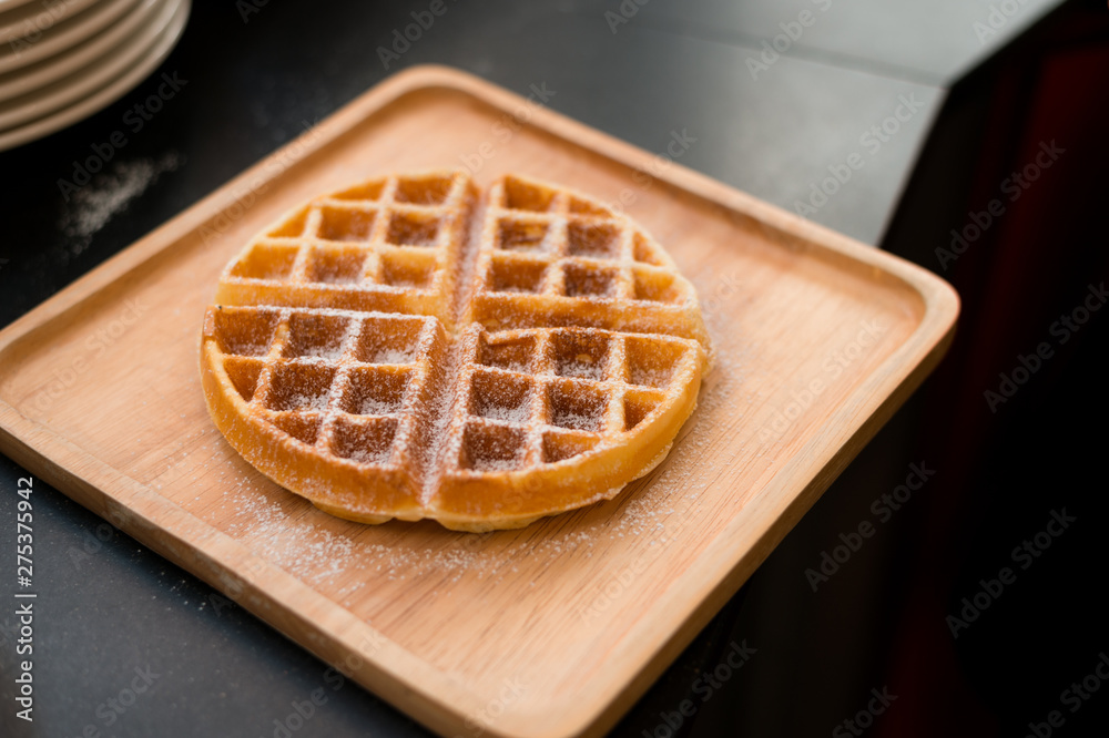 waffles with butter on wooden plate waffles with butter on wooden plate