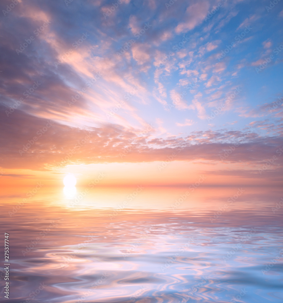Beautiful sunset, bright sun and soft, multicolored clouds against the background of the sea.