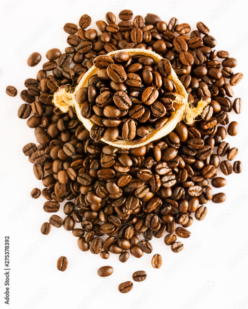 Coffee beans are packed in sacks that are placed on the coffee bean stack on a white background. Coffee beans are packed in sacks that are placed on the coffee bean stack on a white background.