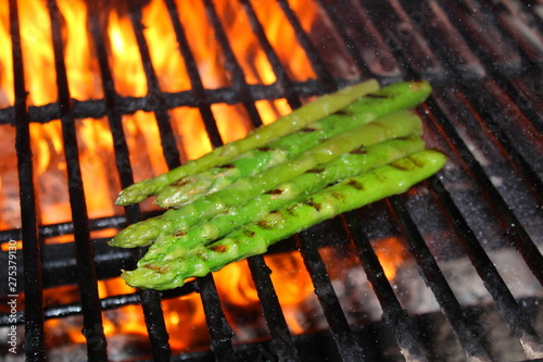 asparagus is cooked on the grill on the fire