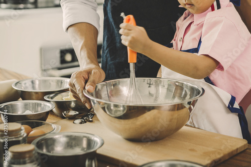 happy family in kitchen. family knead dough and bake the bakery together in kitchen