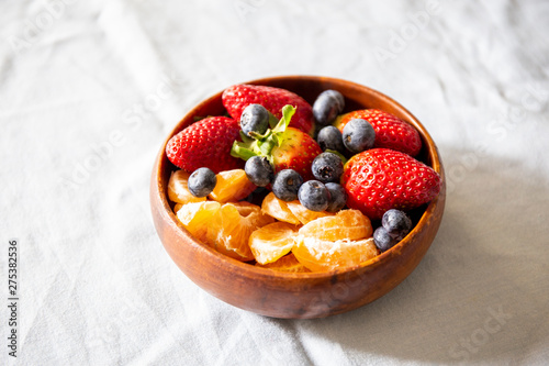 Strawberry, blueberry and madarin in wooden basket photo