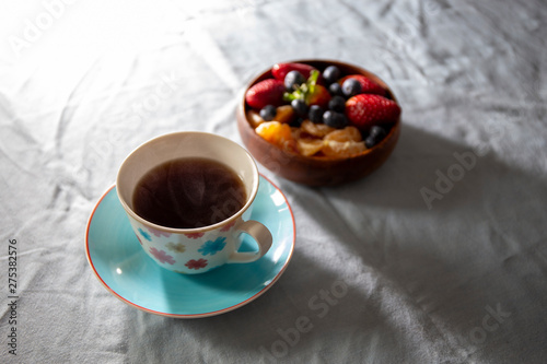 Strawberry, blueberry and madarin in wooden basket with coffee photo