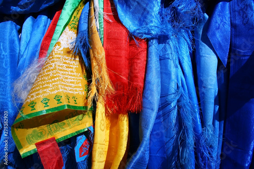 Sacred hadags or khadags (blue silk scarves) and prayer flags close-up, Mongolia. photo