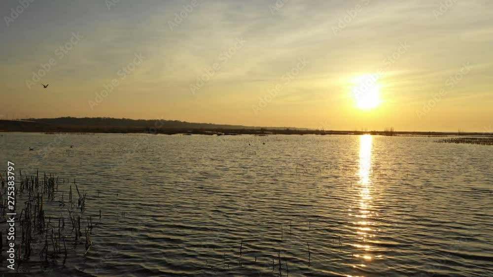 Flying over the water towards the sunset sun Flying over the water towards the sunset sun