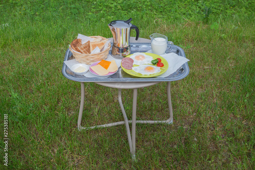 City Amatciems, Latvian republic. Morning breakfast outside. Fried egg, cheese and bread. Travel photo 14. Jun. 2019