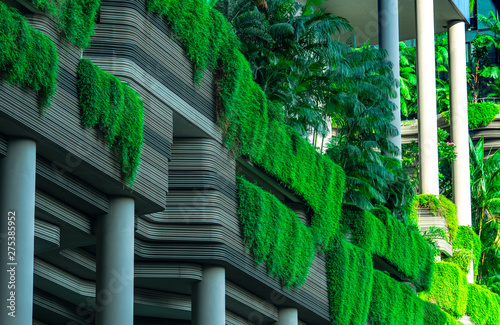 Slika na platnu Eco friendly building with vertical garden in modern city