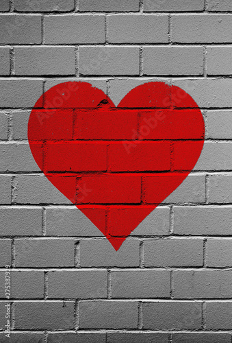 Red heart on a brick wall