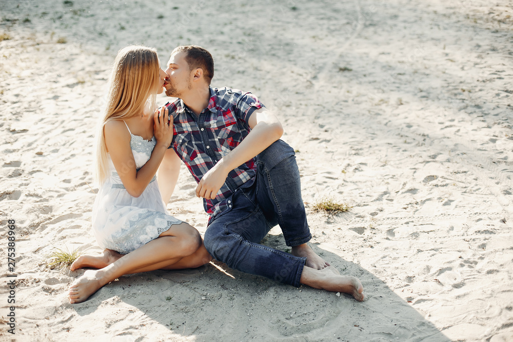 Couple in a park. Woman in a white dress. Man with his wife Couple in a park. Woman in a white dress. Man with his wife