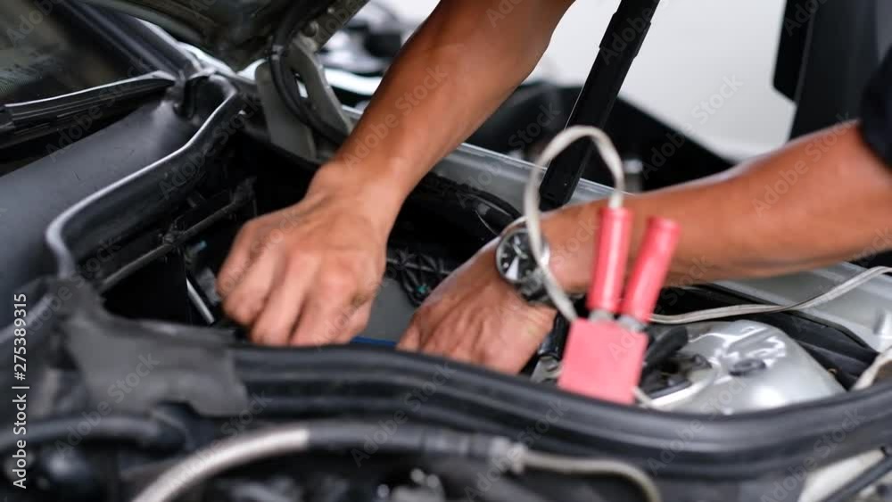 change car battery, mechanic is checking the engine change car battery, mechanic is checking the engine