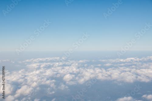 Blue sky with clouds background. View from airplane