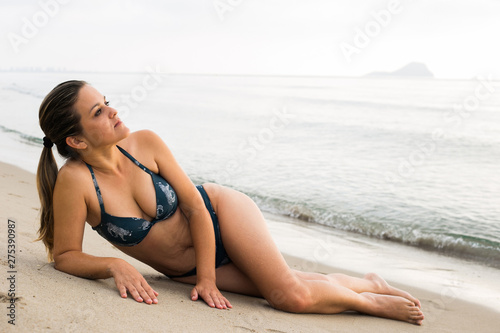 Woman in bikini sunbathing at the seaside