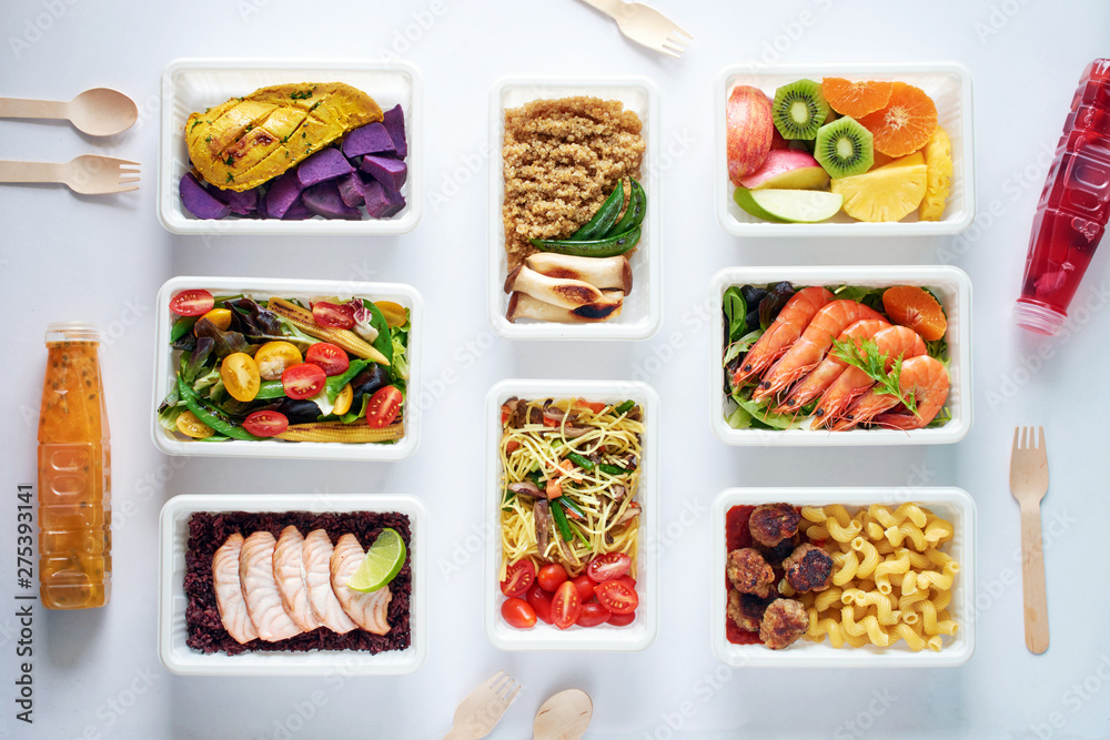 Prepared meal delivery concept. Top view of assorted ready-to-eat dishes over white background. Healthy eating. Prepared meal delivery concept. Top view of assorted ready-to-eat dishes over white background. Healthy eating.