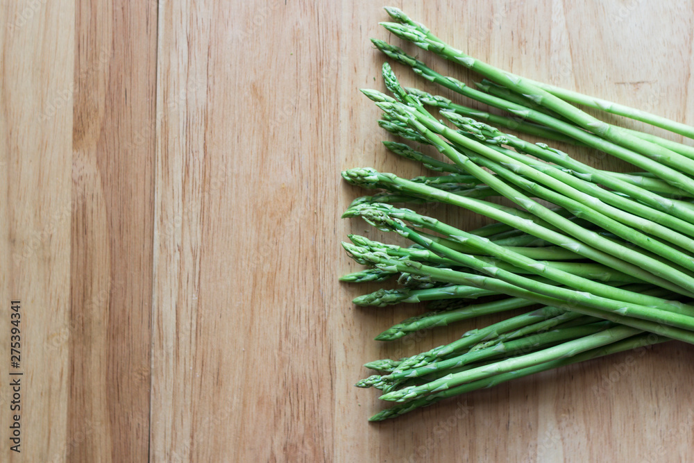 Bunch of fresh raw garden asparagus on wooden table background. Bunch of fresh raw garden asparagus on wooden table background.