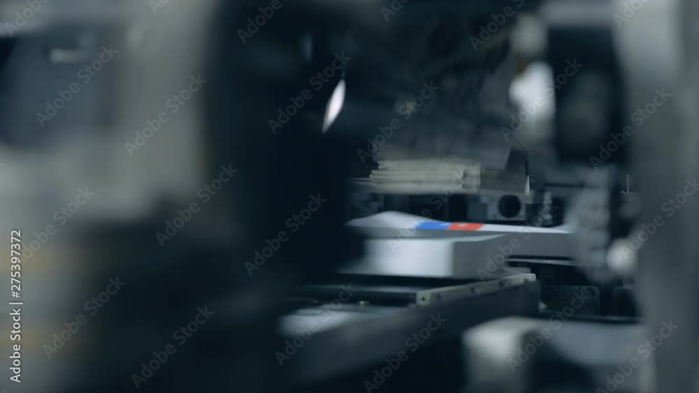 Industrial machine is processing printed books Industrial machine is processing printed books