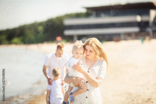 Happy family with two children enjoying summer holiday at beach in Estonia, Tallinn © Olha