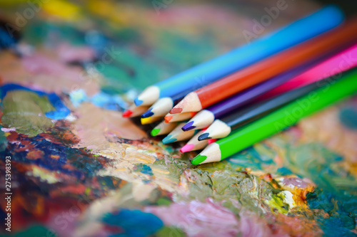 colorful pencils on a paint palette
