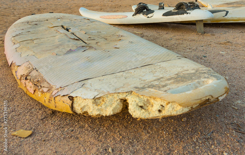 old surfboard lies on the beach