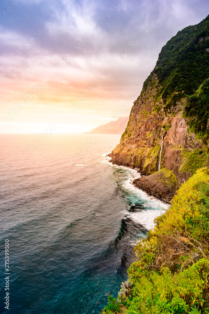 Beautiful wild coast scenery view with Bridal Veil Falls (Veu da noiva) at Ponta do Poiso in Madeira Island. Near Porto Moniz, Seixal, Portugal.