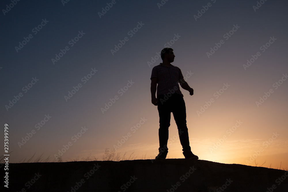 silhouette of man at sunset