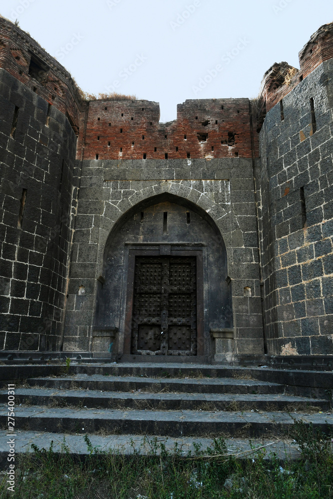 Stone masonry wall and main gate with heavy-duty door at Sardar Purandare Wada, Saswad, Pune Stone masonry wall and main gate with heavy-duty door at Sardar Purandare Wada, Saswad, Pune