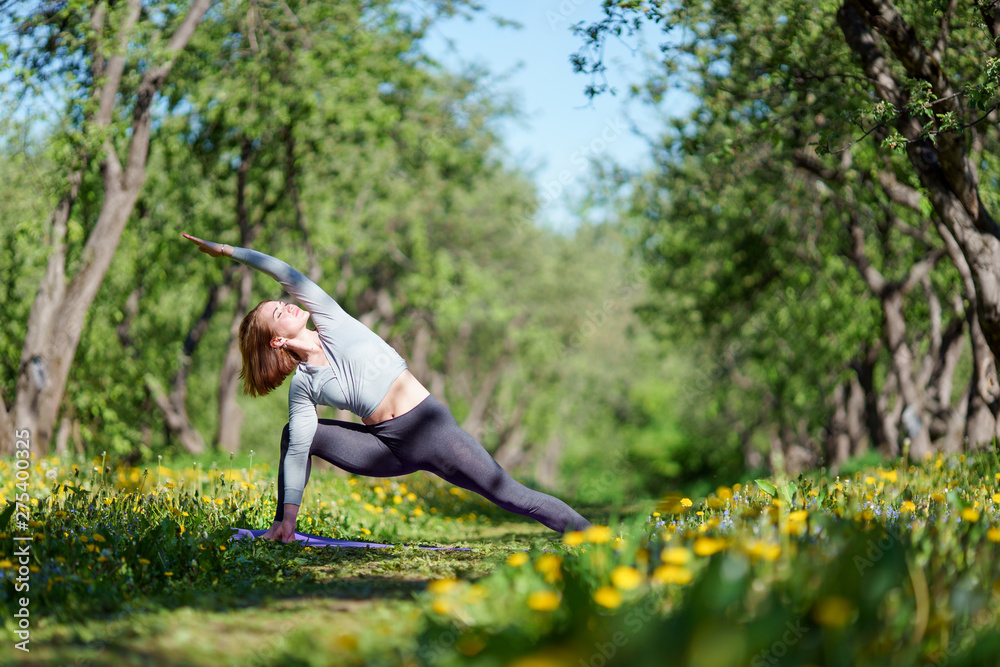 Photo of sport woman doing yoga in forest
