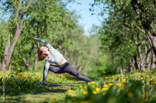 Photo of sport woman doing yoga in forest