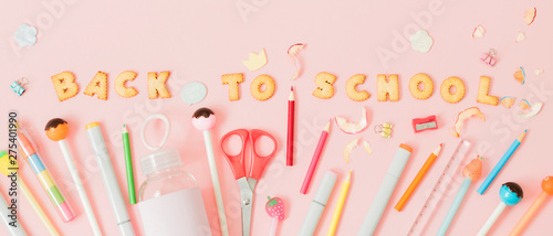 Colorful background with lettering Back to School made of cookies on pink pastel background, school concept