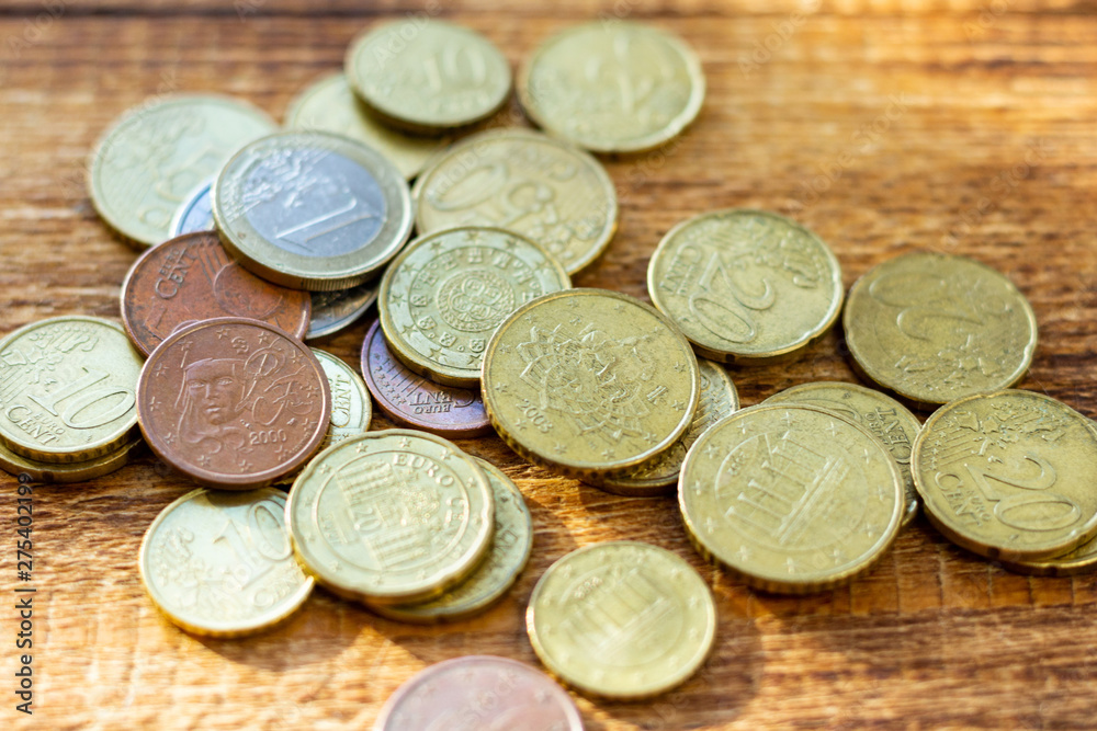 coins old rusty brass euro pile pack heap stack on a wooden background finance economy investment savings concept mock up selective focus close up coins old rusty brass euro pile pack heap stack on a wooden background finance economy investment savings concept mock up selective focus close up