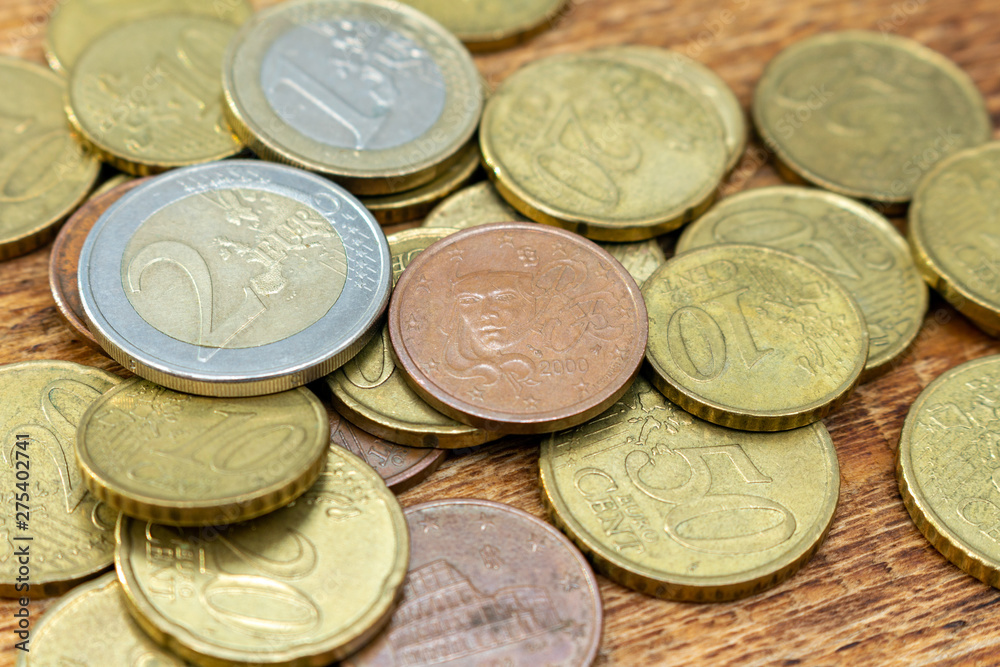 coins old rusty brass euro pile pack heap stack on a wooden background finance economy investment savings concept mock up selective focus close up coins old rusty brass euro pile pack heap stack on a wooden background finance economy investment savings concept mock up selective focus close up
