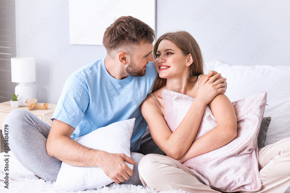 Portrait of happy young couple in bedroom Portrait of happy young couple in bedroom