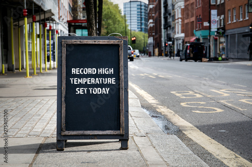 Record high temperature set today. Foldable advertising poster on the street photo