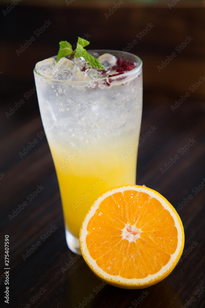 tropical cocktail with passion fruit, orange and mint on a dark background tropical cocktail with passion fruit, orange and mint on a dark background