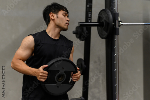 Asian men exercise at the gym