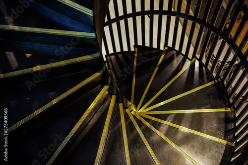 Modern black spiral staircase and bronze metal stair nosing with black handrail high angle view