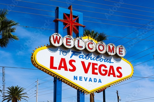 The Welcome to Fabulous Las Vegas sign on bright sunny day in Las Vegas.Welcome to Never Sleep city Las Vegas, Nevada Sign with the heart of Las Vegas scene in the background. photo