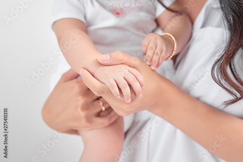 Concept of loving family. Hand baby in the hand of mother closeup.