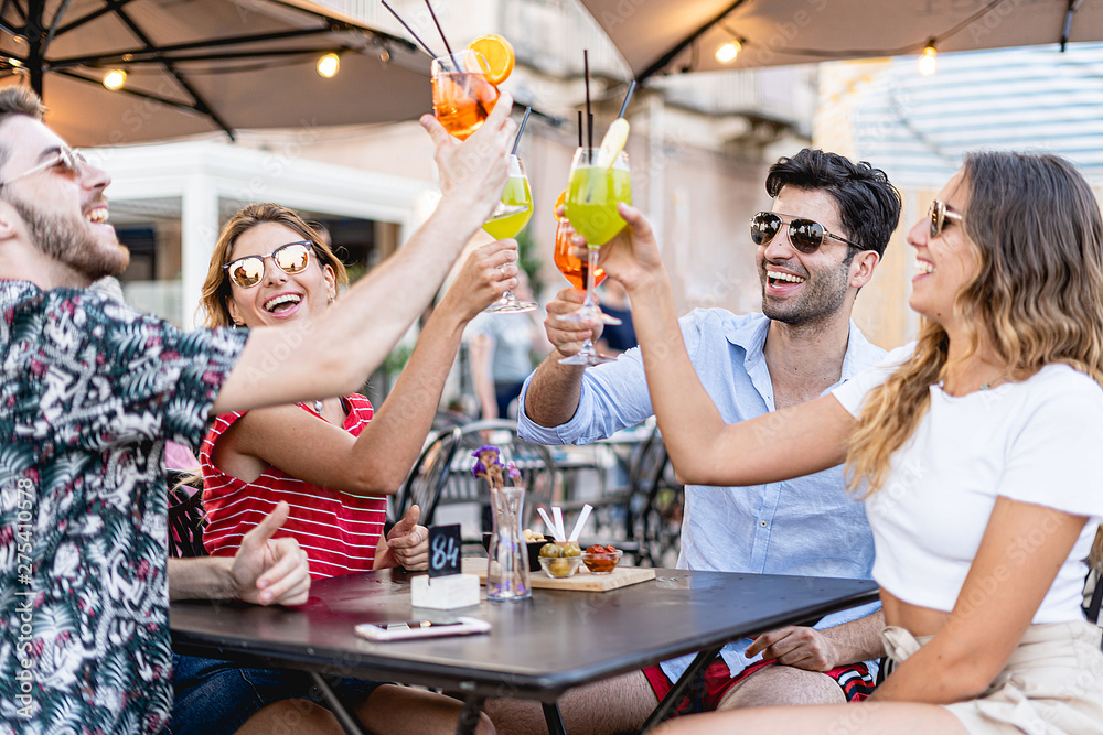© Lomb - Young friends toasting with spritz cocktail at an outdoors restaurant. Youth having fun with alcoholic drinks. Leisure activity summer concept. © Lomb - Young friends toasting with spritz cocktail at an outdoors restaurant. Youth having fun with alcoholic drinks. Leisure activity summer concept.