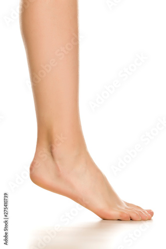 Side view of female bare foot in three different positions on white background © Jasmina