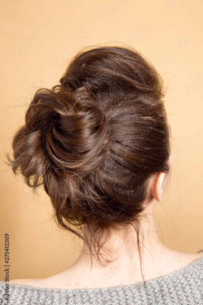 Rear view of female hairstyle middle bun with brown hair Rear view of female hairstyle middle bun with brown hair