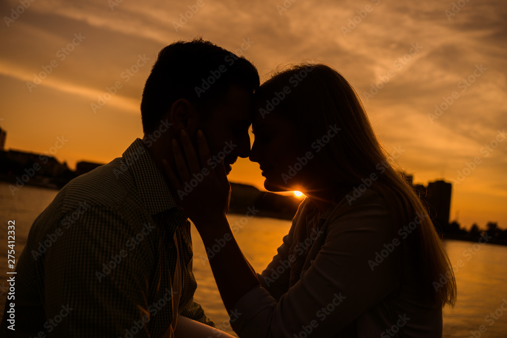 Happy couple in love is enjoying sunset in the city.