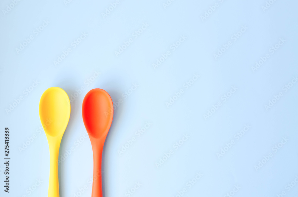 Fletley from multi-colored spoons on a blue background. Fletley from multi-colored spoons on a blue background.