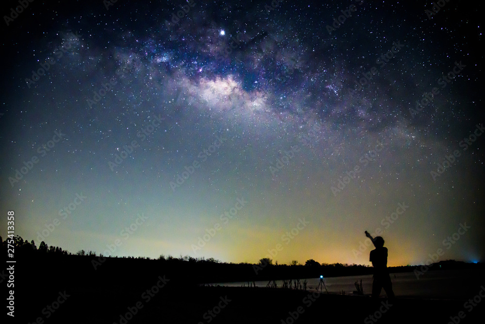 The man standing with milky way / The man point to the milky way